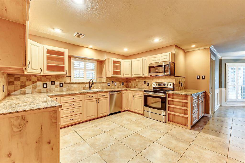 Renovated kitchen with granite and stainless steel