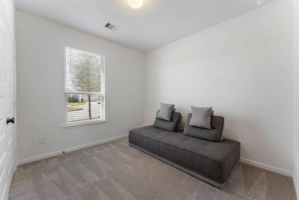 Secondary bedroom #1 is located in the front of the home with double closet and carpet.