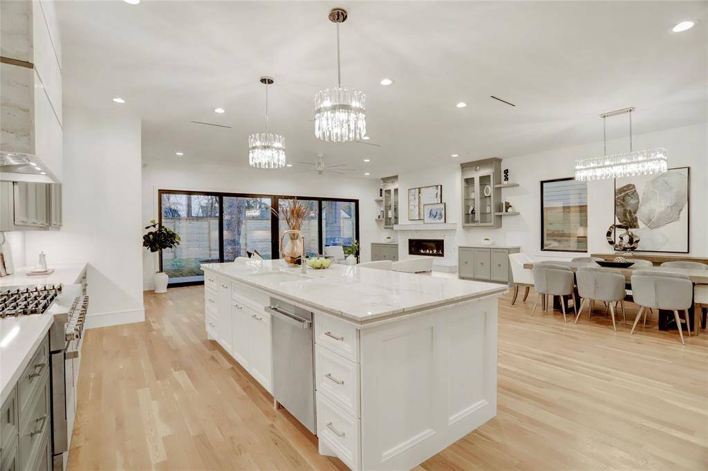 The active side of the huge island has dishwasher ,trash drawer, undermount sink plus drawer storage on both ends.