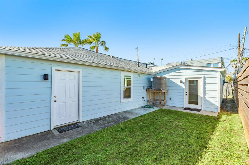 Another view of the back yard.  Door on the left leads to the garage, other door to one of the bedrooms.