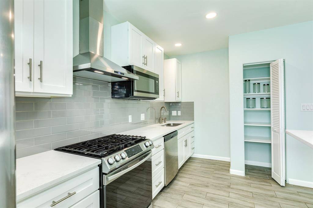 Gas range, dishwasher, microwave, refrigerator and pantry. Soft close cabinets and drawers.