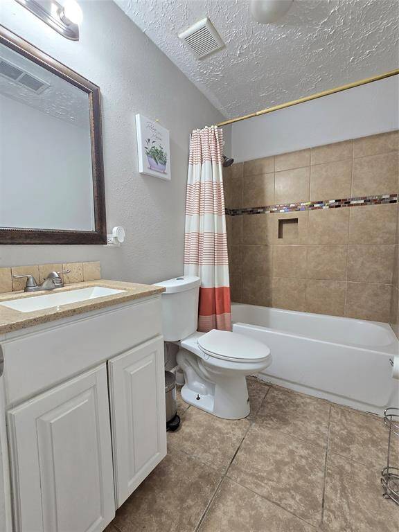 Second Bathroom features tiled flooring, and shower-tub combo with tile surround. Neutral color palette provides a clean, contemporary look.