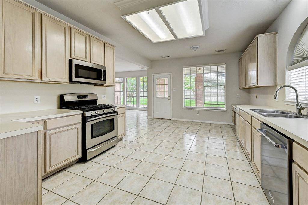 Kitchen boasts a ton of storage, new sink, dishwasher and stove.