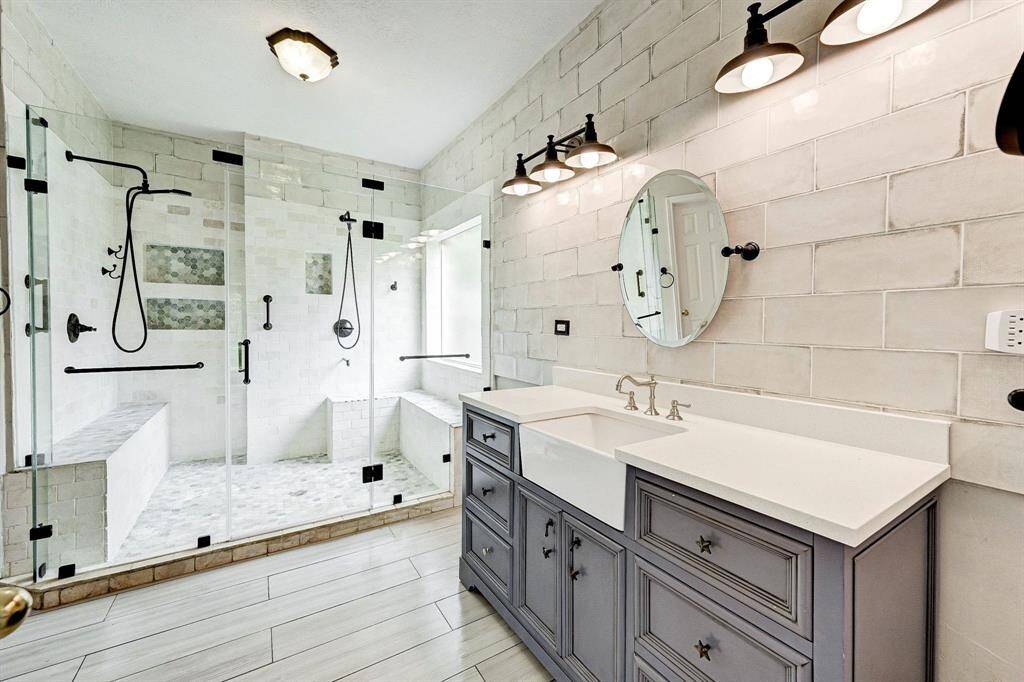 Primary bathroom updated with new vanity, lights and mirror.