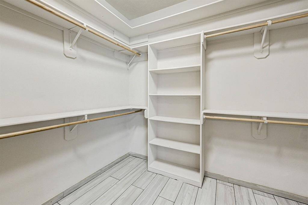 Primary bedroom large walk-in closet with loads of storage space.