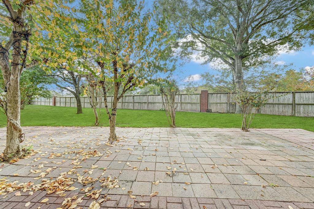 Beautiful paved open patio with mature trees.