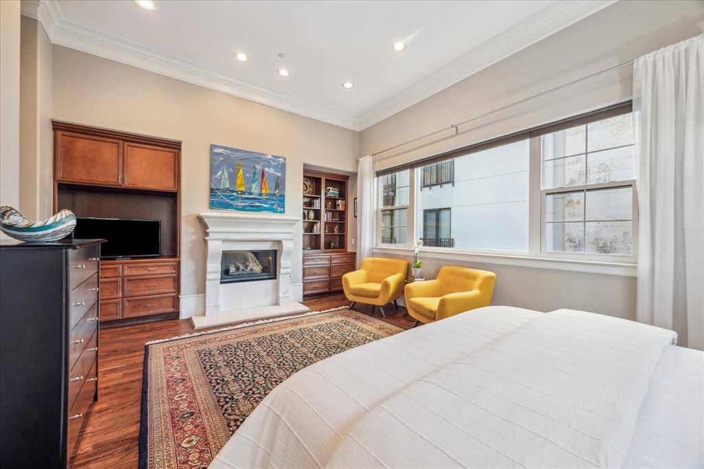 Primary Bedroom II-This alternate view shows the marble fireplace and built-ins