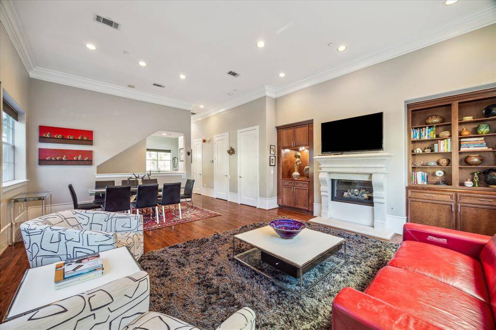 Living Area-The living room has a marble fireplace and built-ins
