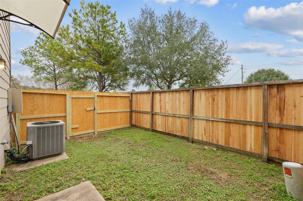 Spacious backyard with new fence.