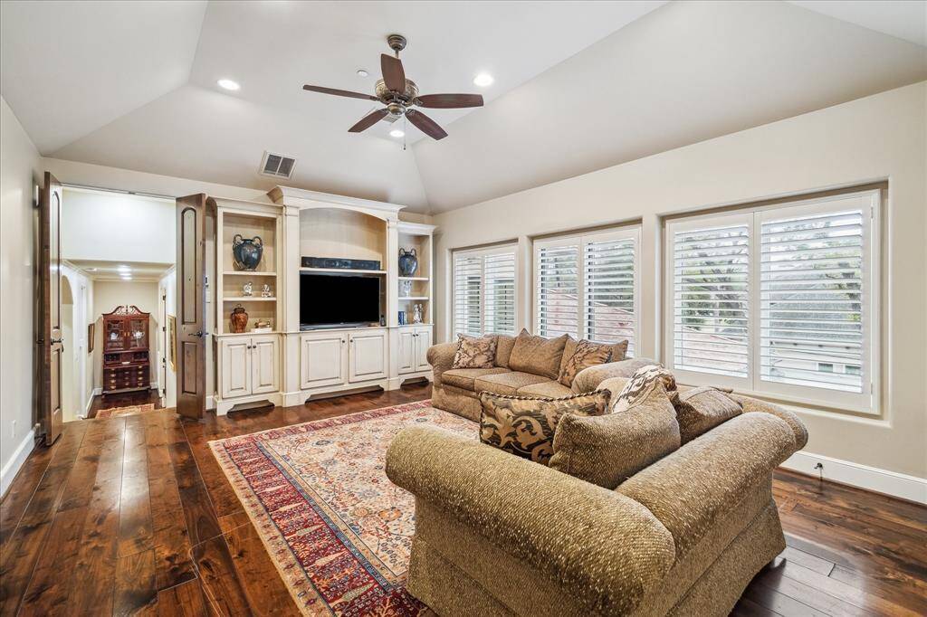 Gameroom with custom built-ins and windows overlooking the pool.