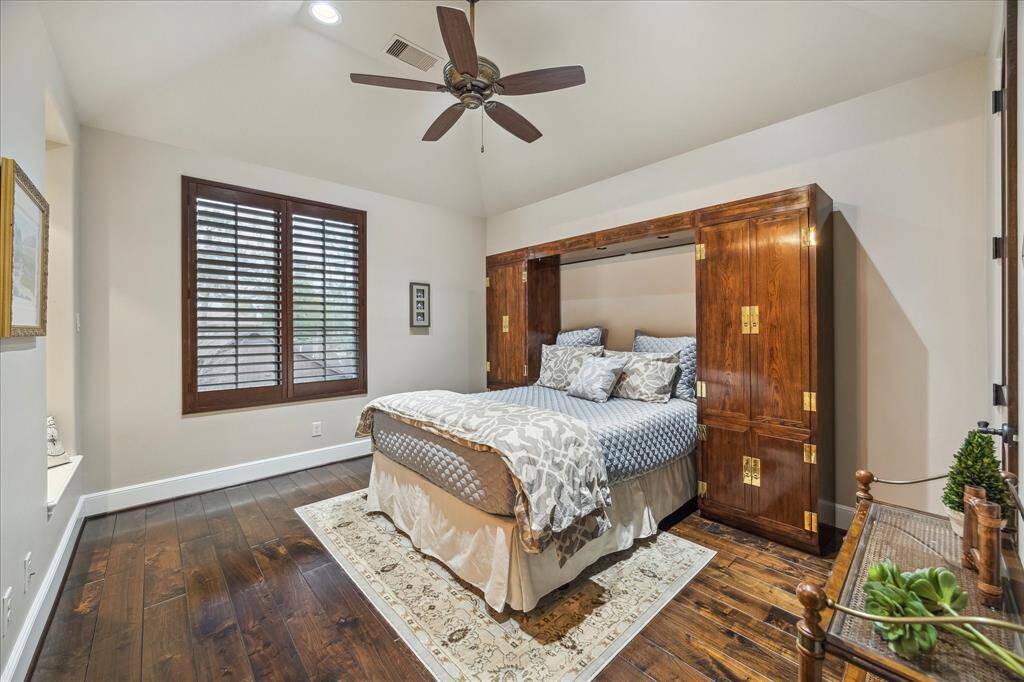 Bedroom 3 has plantation shutters, wood floors and sitting nook.