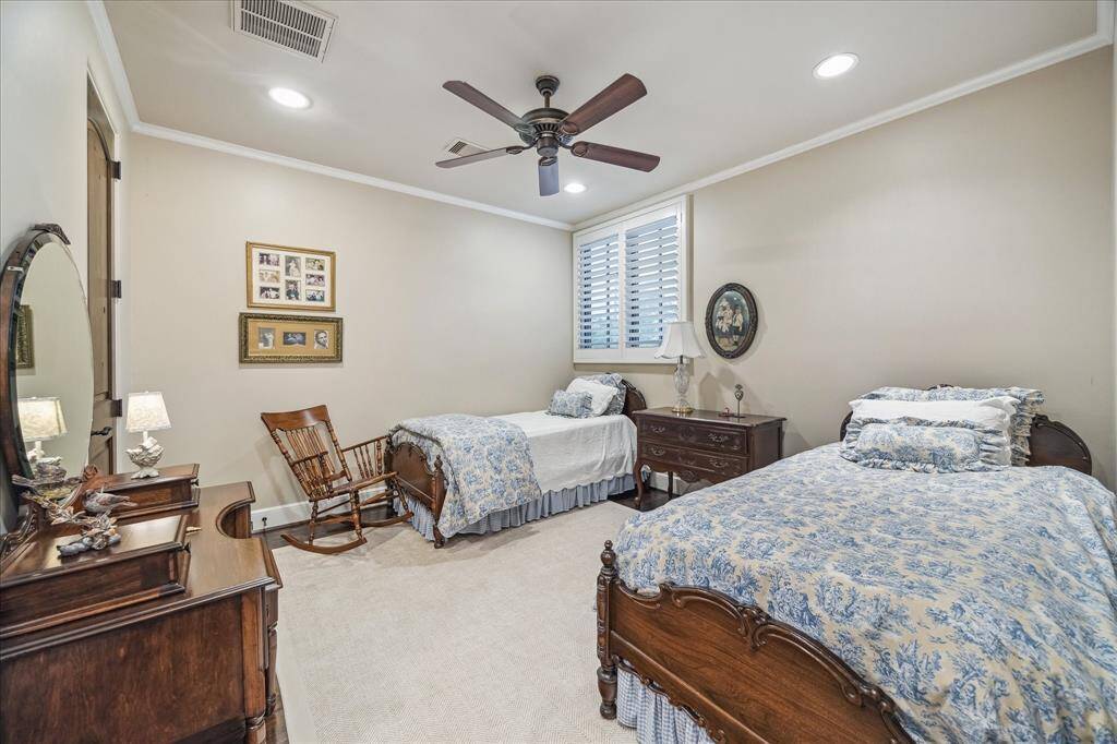Bedroom 4 with two closets, wood floors and plantation shutters.