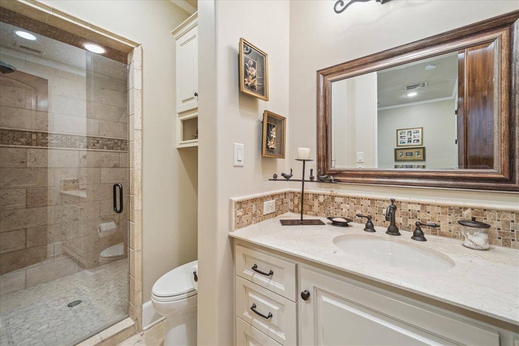 Fourth Bedroom's en-suit bath with walk-in shower and built-in cabinet.