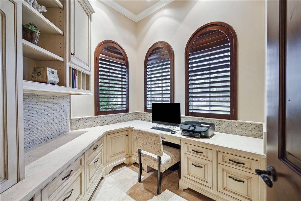 First floor office has a built-in pet crate, custom built-ins and plantation shutters.