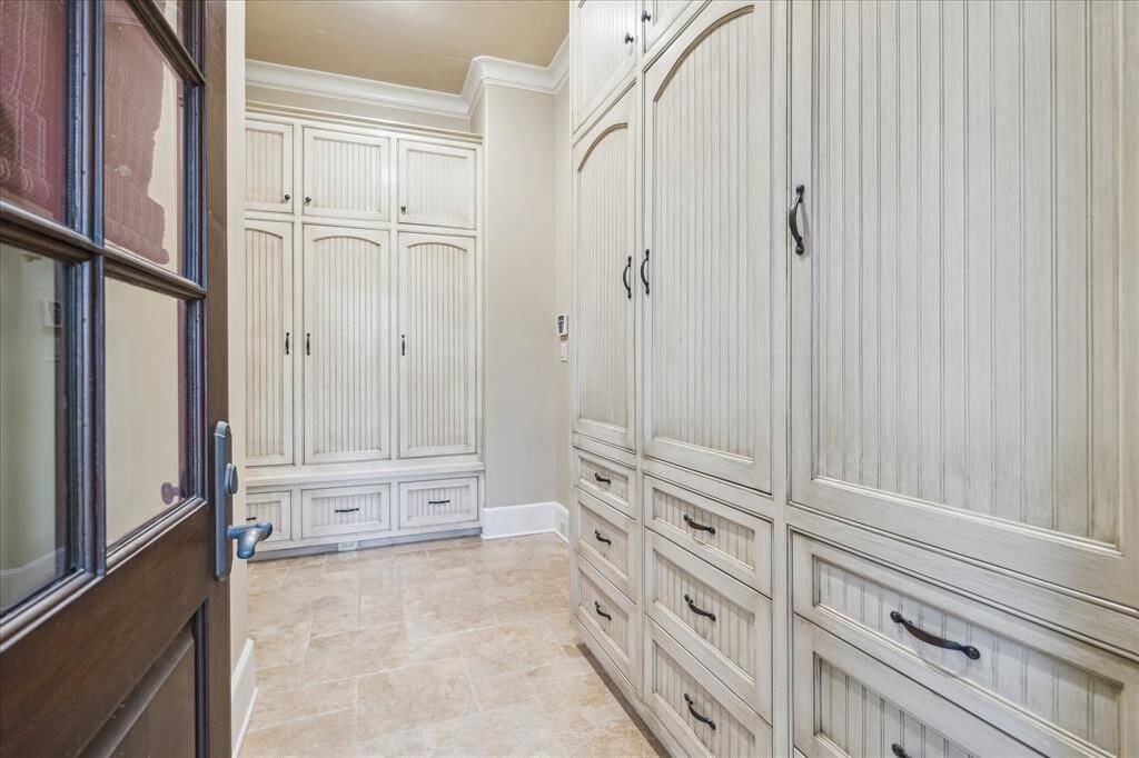 Mud area is off of the garage has built-in custom lockers, drawers and shoe bins.