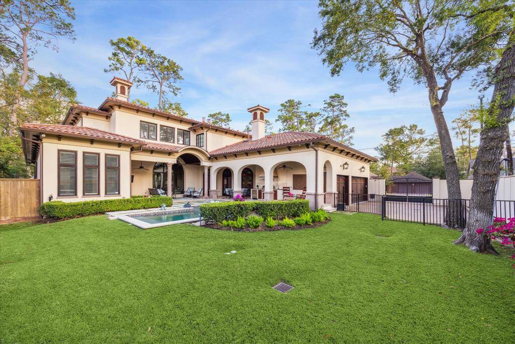 This serene outdoor space features lush green areas that complement the poo.