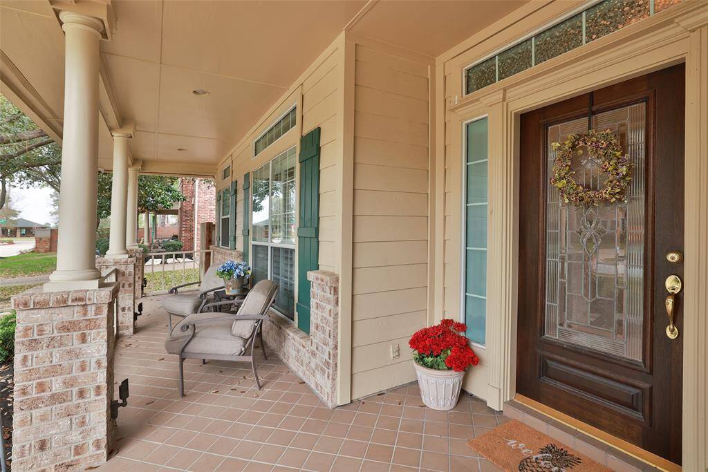 Transom windows and sidelight next to mahogany entry door. Ring doorbell conveys. Accent shutters. Grand pillars with uplighting.