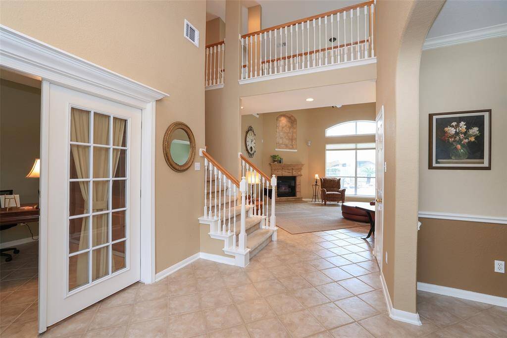 Foyer is Flanked by the study with french doors and offers great views of the pool.