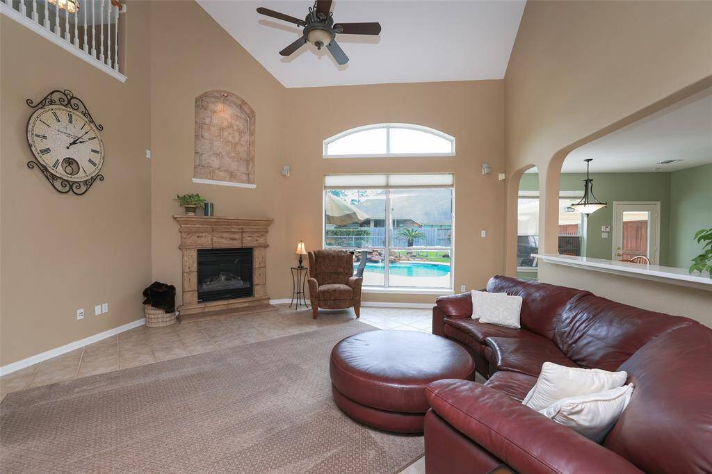 High ceilings, fan with light kit and full window to the backyard and pool.Gas log fireplace.