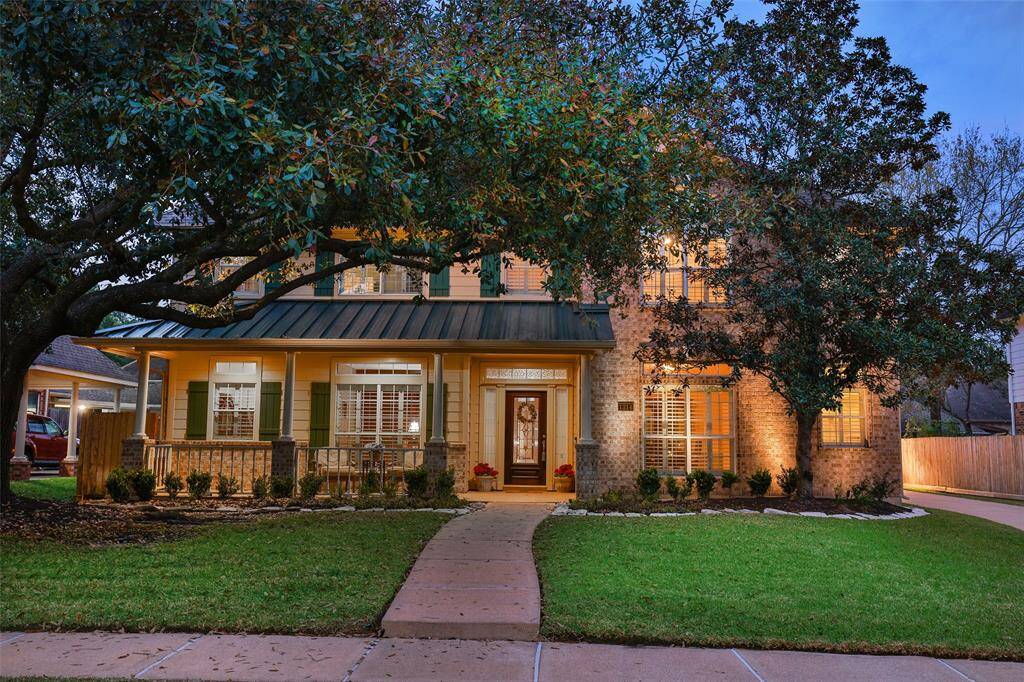 Two story full brick exterior with metal roof over the front porch.