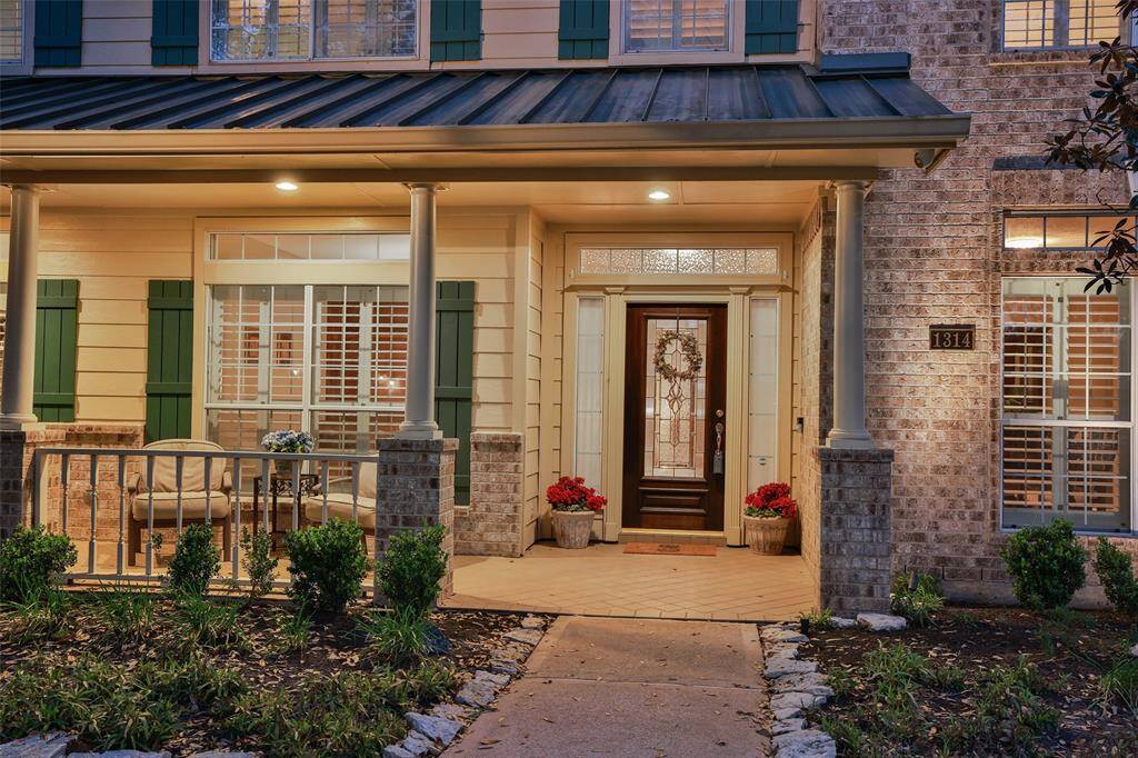 Full length covered Southern style tiled front porch offers coverage from the sun and a great place to visit with neighbors.