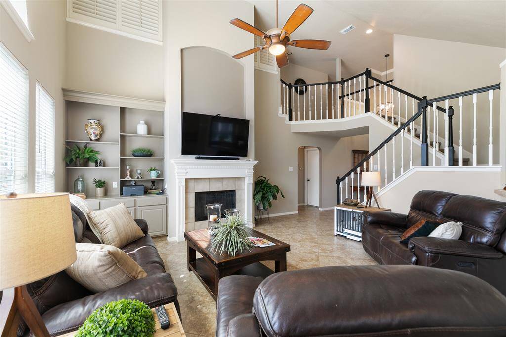Gas log fireplace and built-in high ceiling are a focal point in the family room.