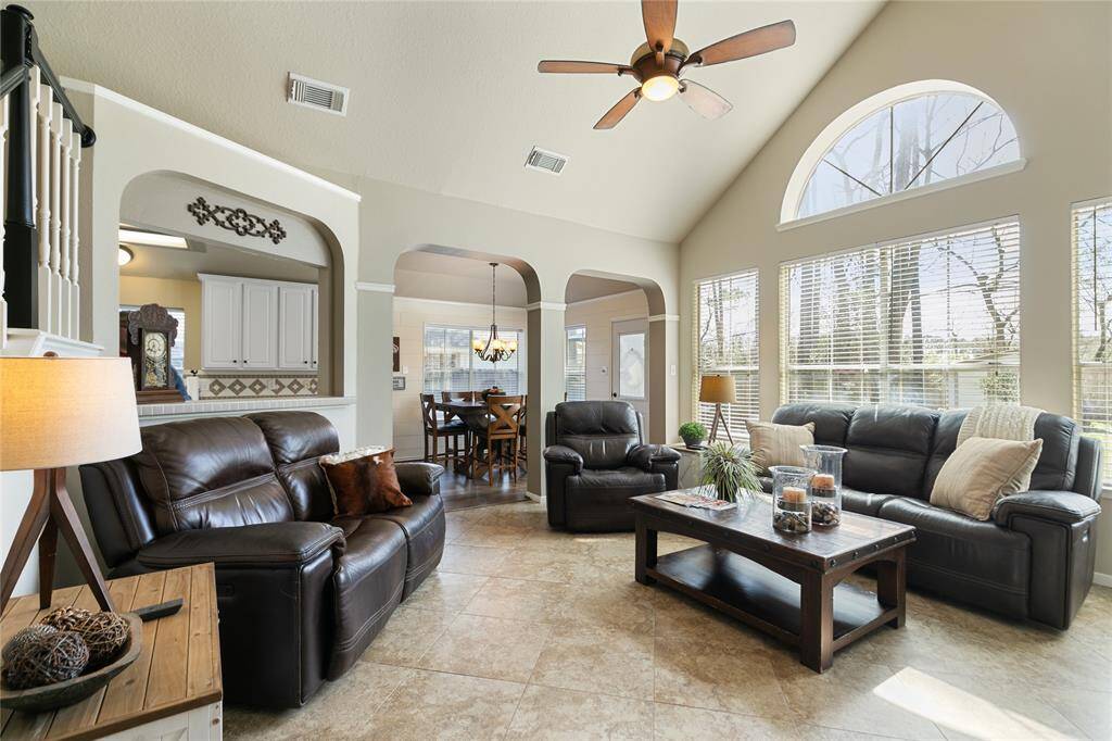 Family room with wall of windows to allow a view of the yard and let in lots of light in. Tile floors in the entry family room and flexable room 3 years old.