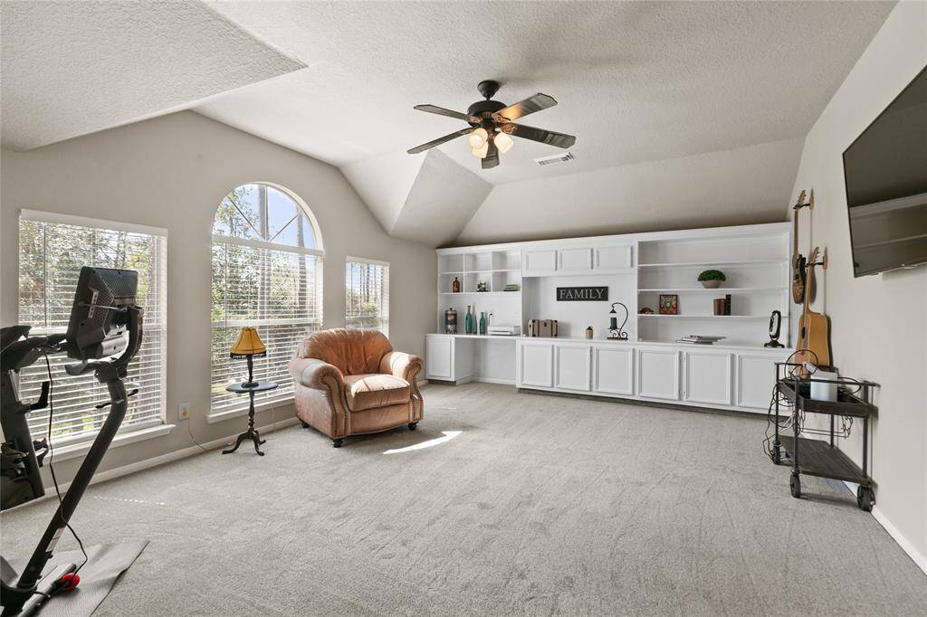 Large Gameroom up with builtin desk sheves and storage