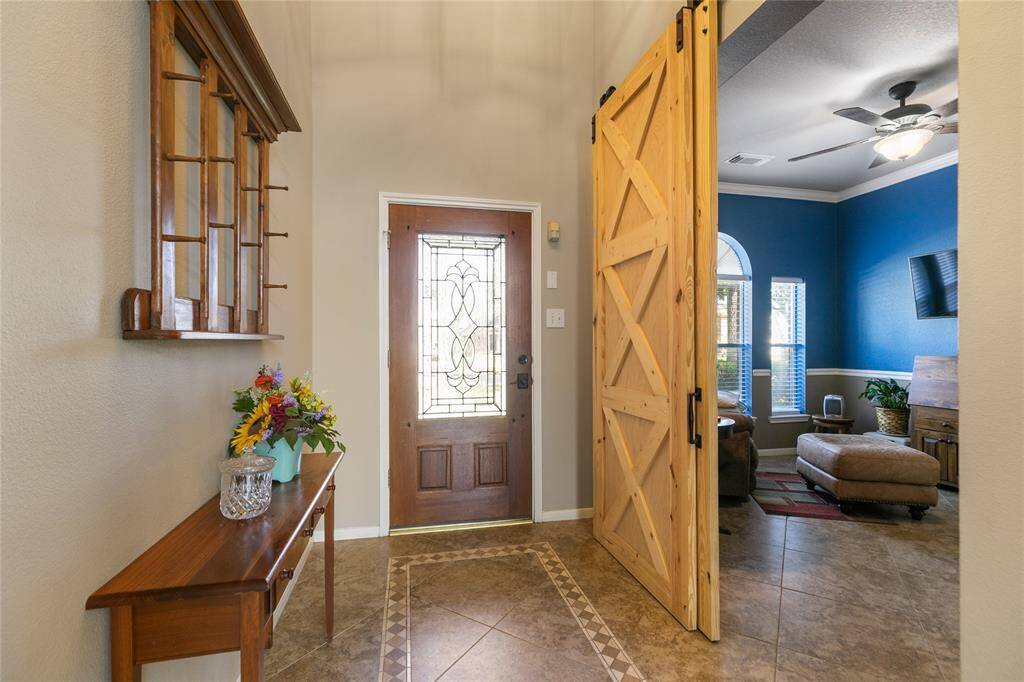Entry with leaded front door, and Fabulous natral barndoors to the formal dining/sitting or study.