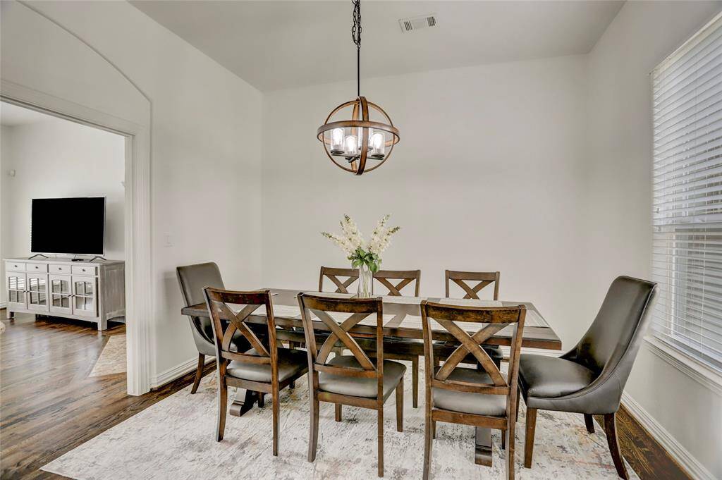 Showcasing the open layout, this view connects the dining area to the chef’s kitchen, emphasizing entertaining potential.