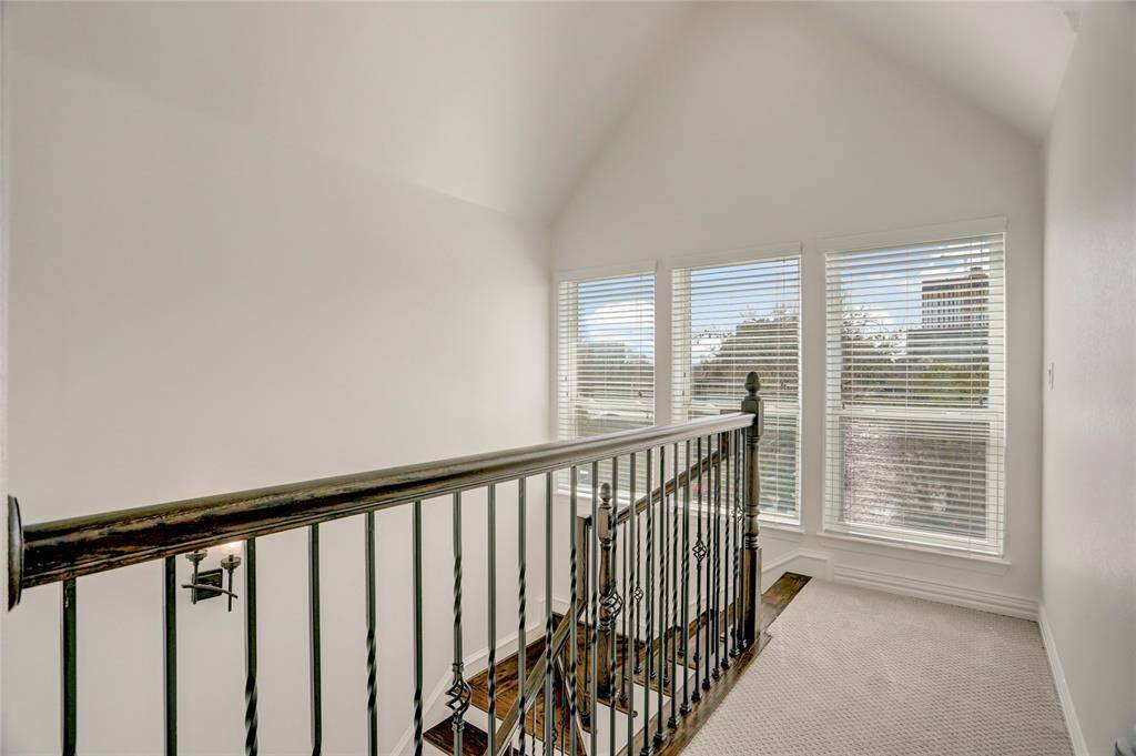 The second-floor landing features sleek railings and leads to the private balcony, perfect for fresh air and relaxation.