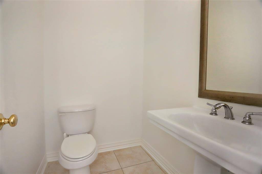 A chic half-bath featuring a stylish vanity, sleek fixtures, and modern accents for guests’ convenience.