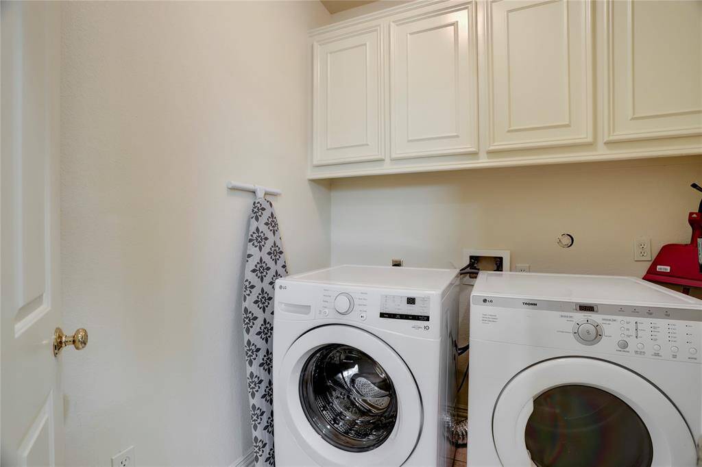 Keep things organized and stylish in the laundry room, featuring built-in cabinets that provide ample storage and streamline your household chores.