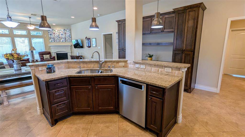 Open kitchen features granite countertops, stainless steel appliances & touchless faucet
