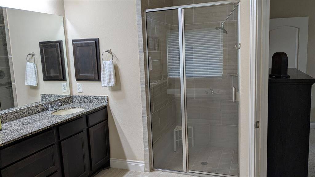 separate shower with safety handles if needed