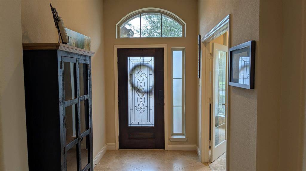 Bright entryway with private office to the right