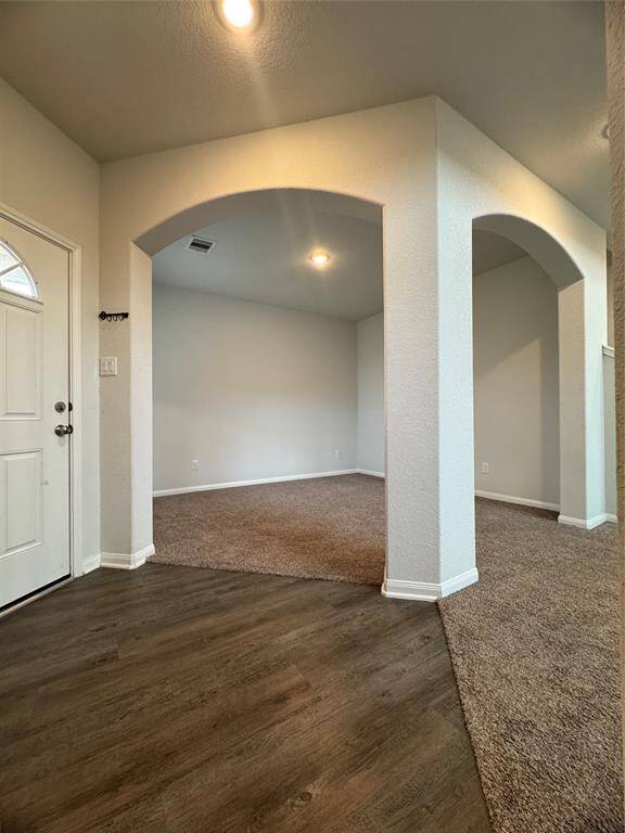 Hallway right of entry leading to laundry room and garage