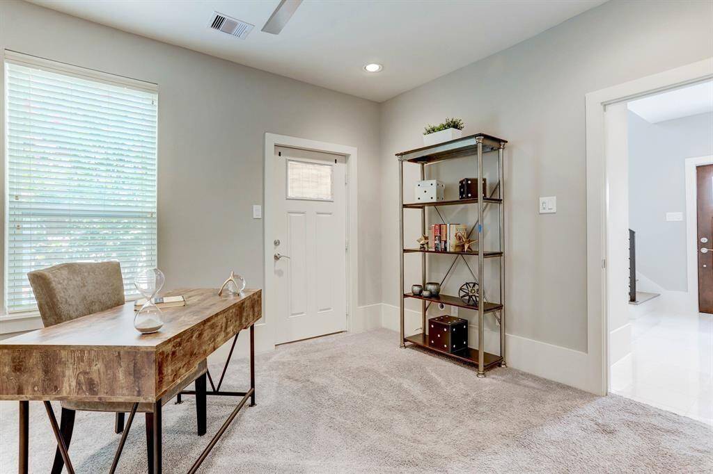 First floor bedroom is ideal for a home office, gym, or guest suite.