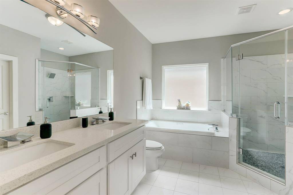 Primary en suite bathroom with garden tub and walk-in shower. This is exactly what the doctor meant when he said rest and relaxation.