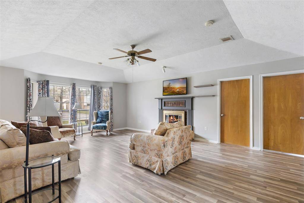 Living Room with fireplace, vaulted ceiling, and view of front yard