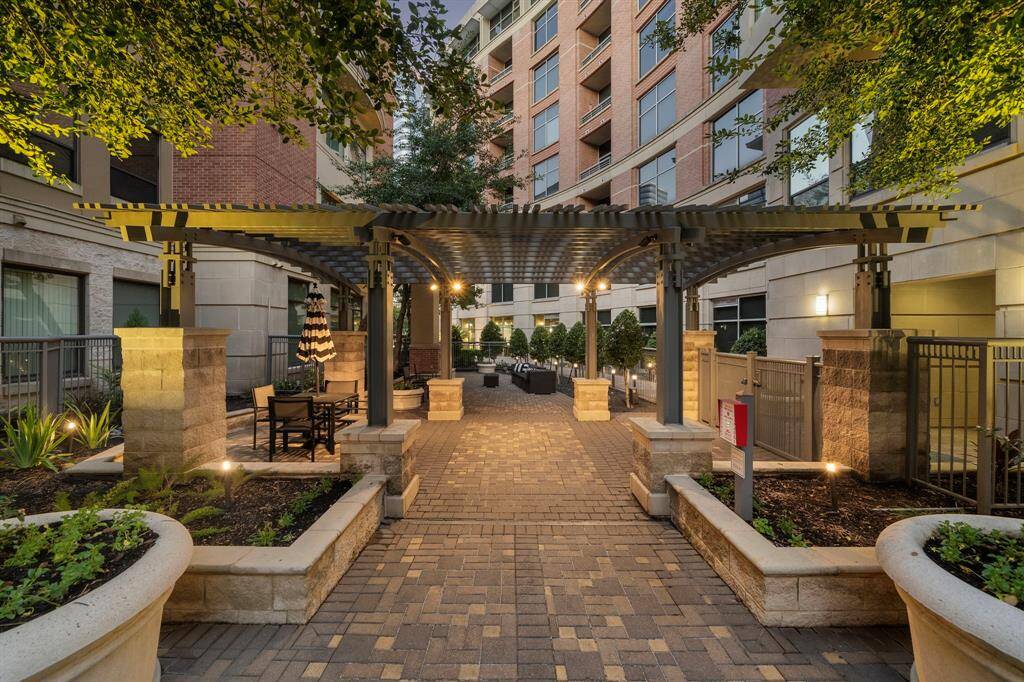 Enjoy outdoor gatherings in this elegant courtyard featuring a charming pergola set above stylish paver tiles. Comfortable seating areas are perfectly positioned amidst well-maintained landscaping.