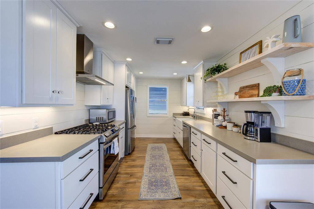 Renovated kitchen with quartz counters, amble storage space, and stainless steel appliances!