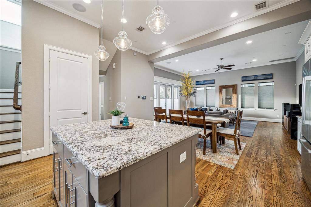 This home showcases an open concept living area with hardwood floors.