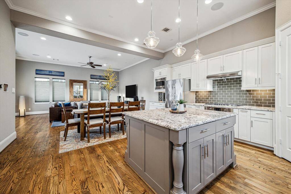 The Kitchen seamlessly flows into a cozy living area with ample natural light, perfect for entertaining.