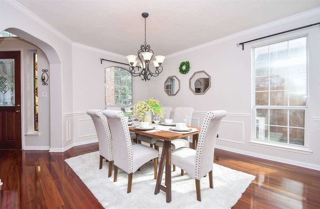Another view of the dining room with two large windows and enough space for a buffet and a China cabinet.