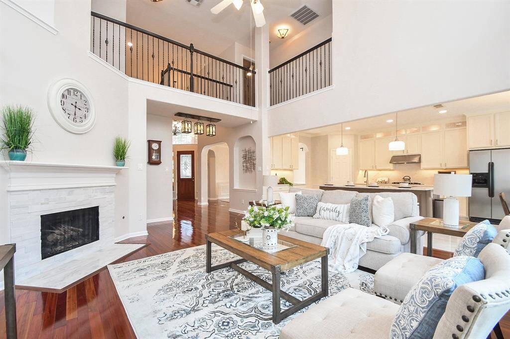 Another view of the living room with a freshly finished marble fireplace and high ceiling living room
