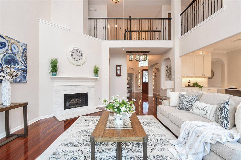 View from the window side of the room showcasing the large living room, gas fireplace, and ample place for a TV above the fireplace or an entertainment center.
