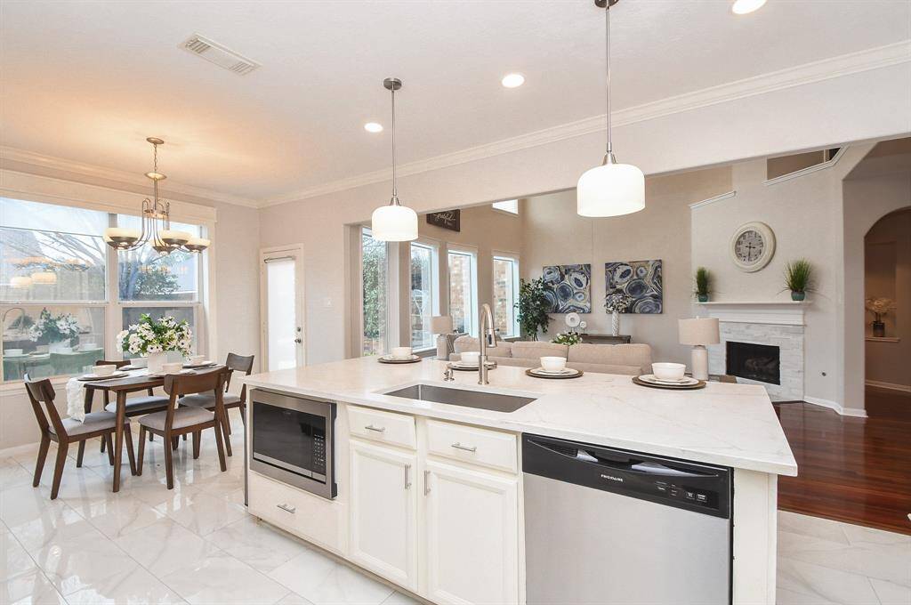 The kitchen renovation includes brand new microwave, dishwasher and above the island light fixtures. The island includes new sunken sink and faucets.