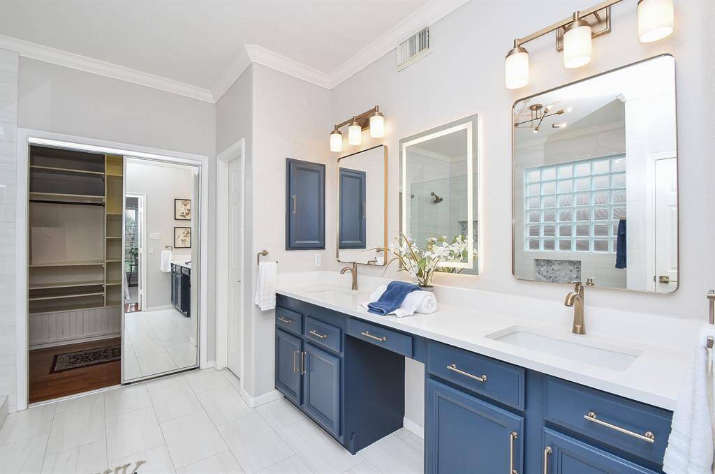 Another view of the bathroom with access to a large walk-in closet and customer shelves.