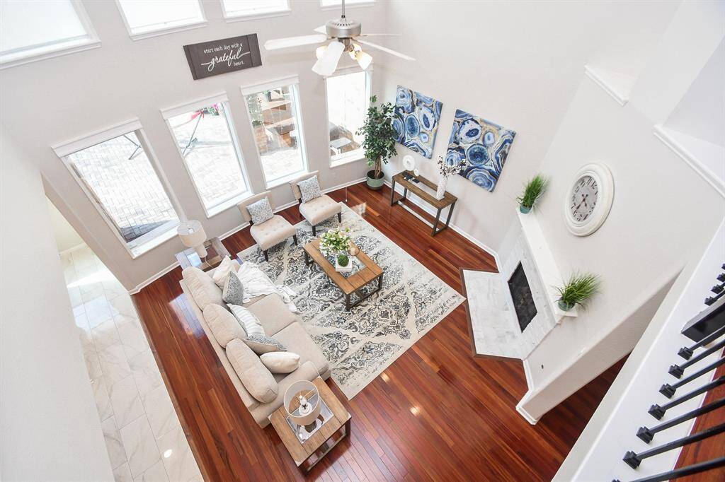 TA view from the top showing the open living room, large windows, and plenty of space for entertaining.